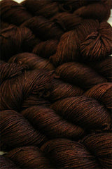 Fingering weight yarn from Zen Yarn Garden's Serenity 20 collection in a warm, rich chestnut color, displayed in skein form.