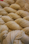 Fingering weight yarn from Zen Yarn Garden, Serenity 20 in a soft French Vanilla color, displayed in a close-up shot.