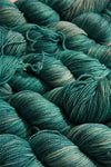 Fingering weight yarn from Zen Yarn Garden's Serenity 20 collection in soft menthol green, showcasing smooth, spun fibers.