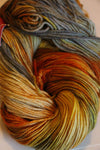 Close-up of Zen Yarn Garden Serenity 20 fingering weight yarn in vibrant koi color, showcasing its soft texture and fine fiber details.