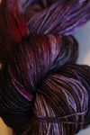 Fingering weight yarn from Zen Yarn Garden's Serenity 20 collection in a soft velvet cake colorway, showcasing the textured fiber.