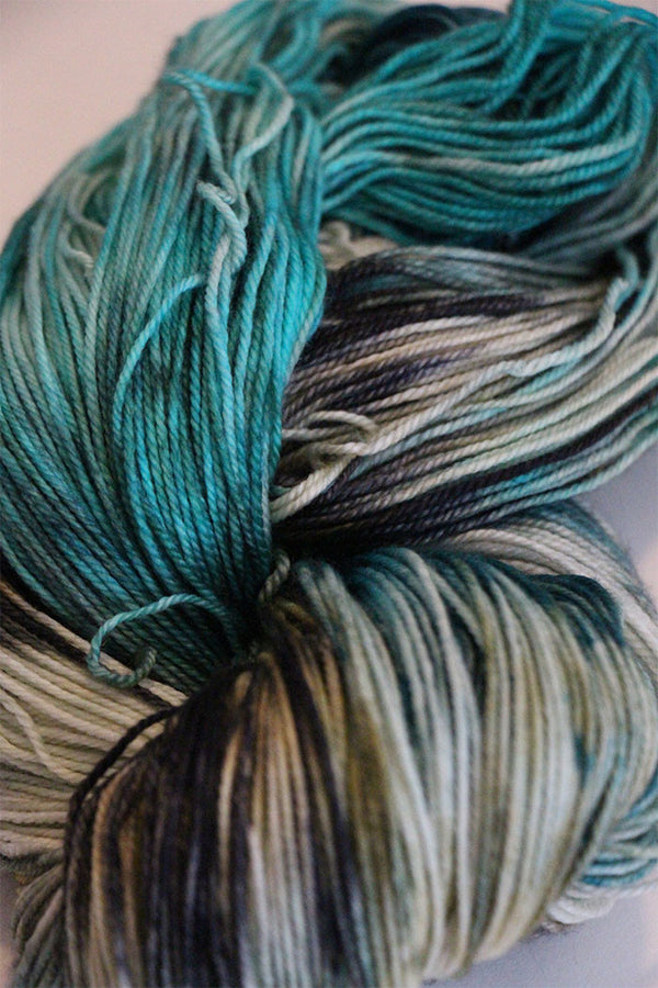 Close-up of Zen Yarn Garden Serenity 20 fingering weight yarn in deep jet black with subtle sheen and fine texture.