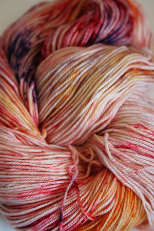 Close-up of Zen Yarn Garden Serenity 20 fingering weight yarn in soft, variegated colors, showcasing its smooth texture and vibrant hues.