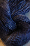 Fingering weight yarn from Zen Yarn Garden's Serenity 20 collection in frosted berry color with soft, variegated pink and purple tones.