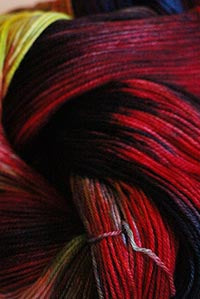 Close-up of Zen Yarn Garden Serenity 20 fingering weight yarn in vibrant red, showcasing its soft texture and fine gauge.