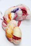 Fingering weight yarn Zen Yarn Garden Serenity 20 in a vibrant, multicolored skein with rich, variegated hues for knitting or crochet projects.