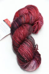 Fingering weight yarn from Zen Yarn Garden's Serenity 20 collection, colorway Vixen, showing soft, vibrant fibers and texture.