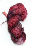 Fingering weight yarn from Zen Yarn Garden's Serenity 20 collection, colorway Vixen, showing soft, vibrant fibers and texture.