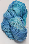 Fingering weight Serenity 20 yarn from Zen Yarn Garden, featuring soft, tranquil fiber in a natural fiber bundle.