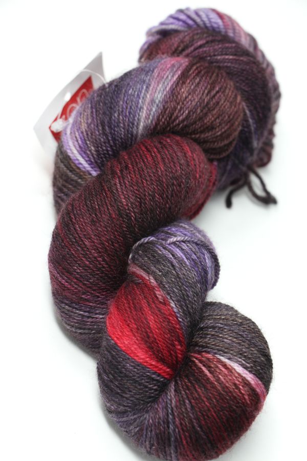 Fingering weight yarn by Zen Yarn Garden in Velvet Cake colorway, showcasing soft, vibrant pink tones and smooth fiber texture.