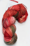 Fingering weight yarn from Zen Yarn Garden's Serenity 20 collection in a strawberries colorway, showcasing soft, vibrant fibers.