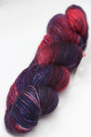 Fingering weight yarn from Zen Yarn Garden's Serenity 20 collection in Jazzy Berry colorway, showcasing vibrant, soft fiber texture.