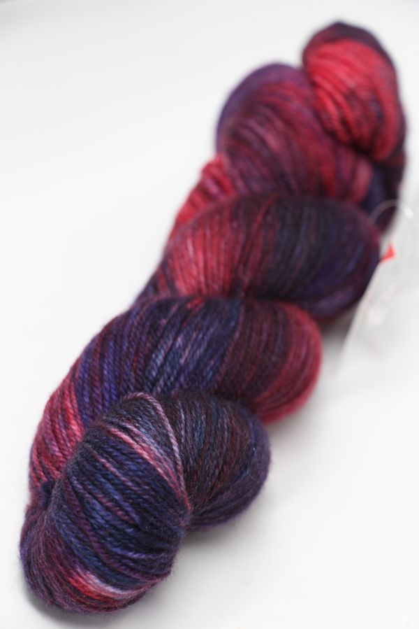 Fingering weight yarn from Zen Yarn Garden's Serenity 20 collection in Jazzy Berry colorway, showcasing vibrant, soft fiber texture.