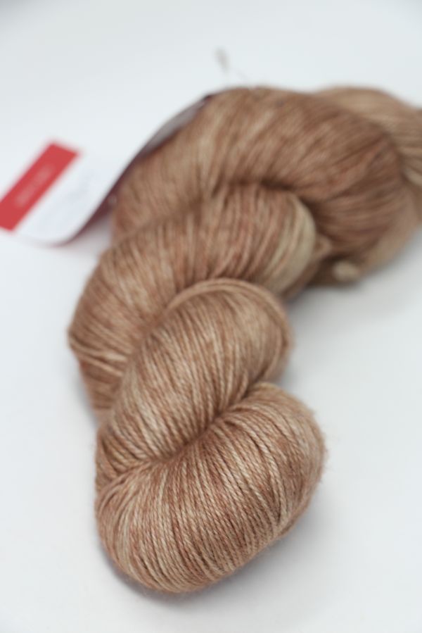 Fingering weight yarn from Zen Yarn Garden's Serenity 20 collection in Latte color, showcasing soft, variegated fiber texture.