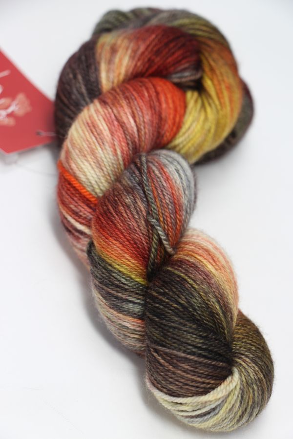 Fingering weight yarn from Zen Yarn Garden's Serenity 20 collection in a vibrant Razzle color, shown in a close-up of the yarn skein.