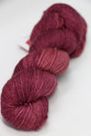 Fingering weight yarn from Zen Yarn Garden's Serenity 20 collection in a soft blush color, showcasing smooth, high-quality fiber.