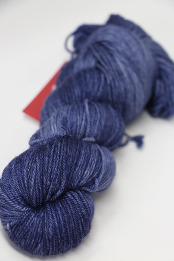 Fingering weight yarn by Zen Yarn Garden, Serenity 20 in frosted berry color, showcasing soft texture and vibrant hue.