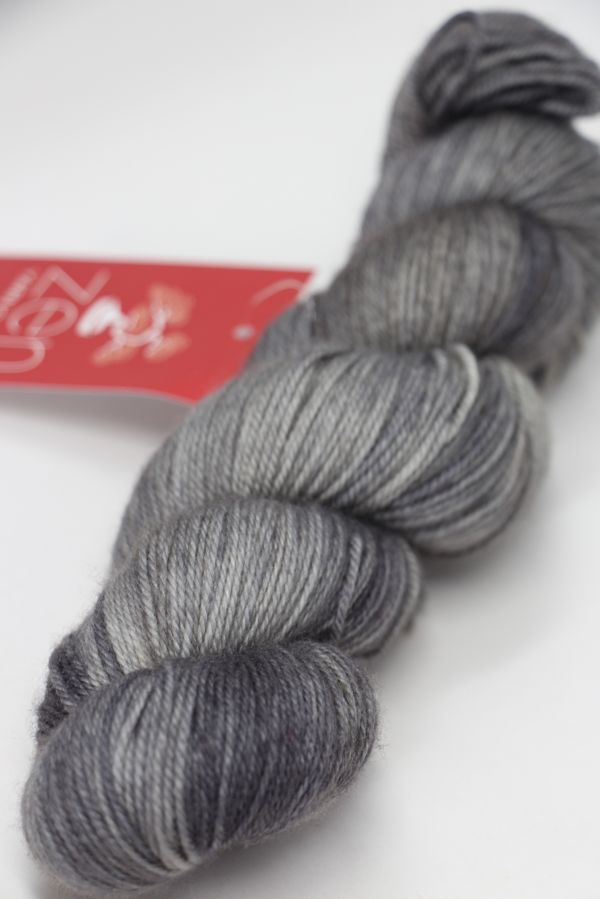 Zen Yarn Garden Serenity 20 fingering weight yarn in Grey Wolf color, showcasing soft, variegated yarn with subtle color transitions.