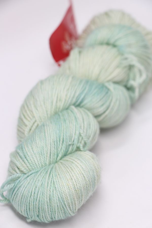 Fingering weight yarn from Zen Yarn Garden's Serenity 20 collection in African Jade color, soft and vibrant for knitting projects.
