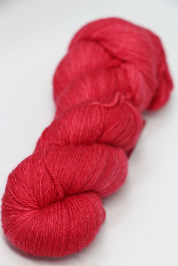Fingering weight yarn from Zen Yarn Garden's Serenity 20 collection in frosted rose color, with soft, delicate fibers.