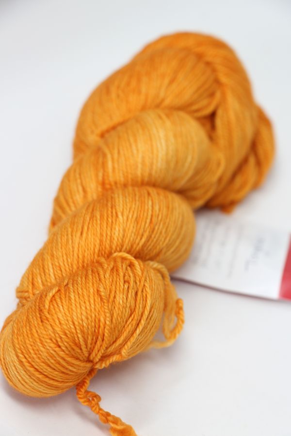 Fingering weight yarn from Zen Yarn Garden, Serenity 20 in vibrant tangerine color, showcasing soft, smooth yarn fibers.